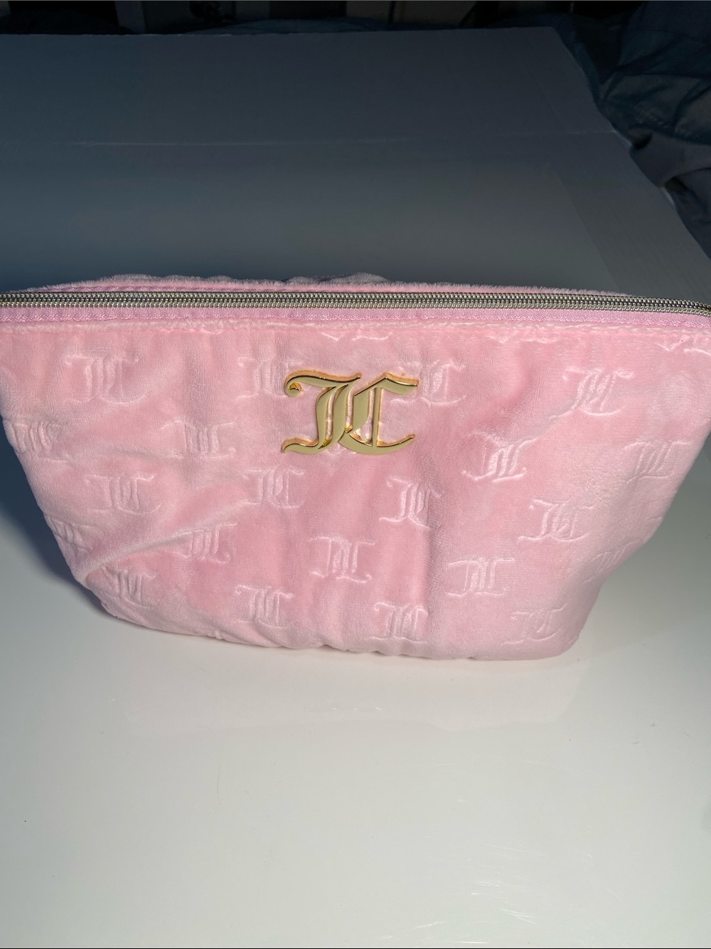 Juicy Couture velour cosmetic pouch in pink with a gold-tone "JC" monogram